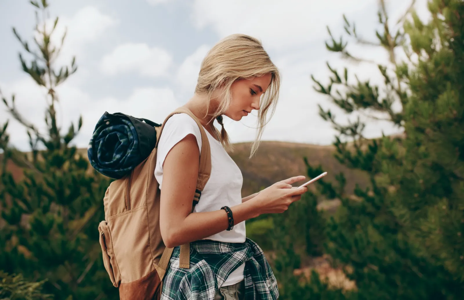 A small business owner checking her phone away from her desk