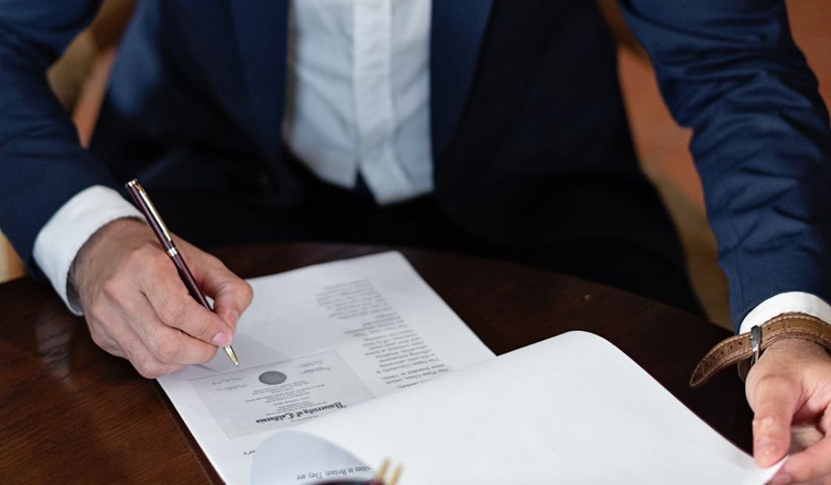 A freelancer signing a legal document