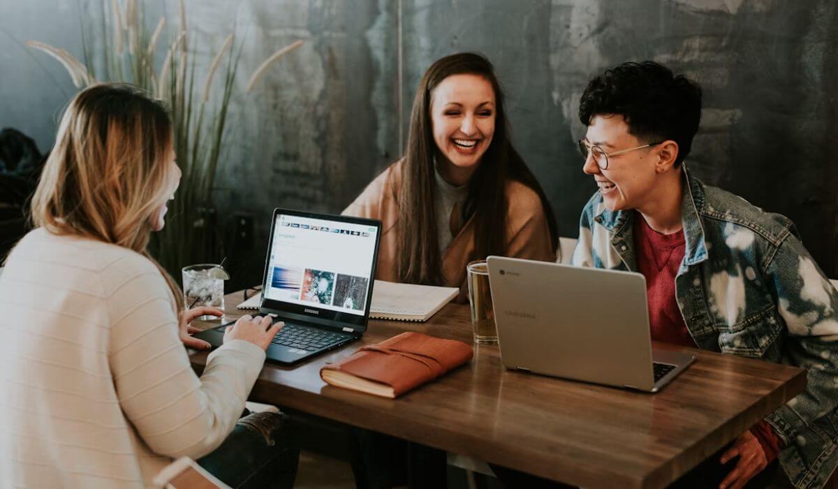 three employees sitting at their workplace