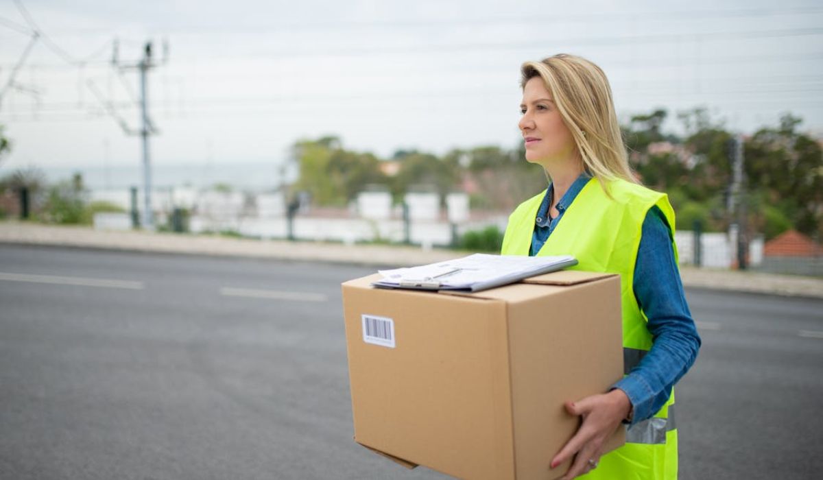 A delivery woman holding a delivery box
