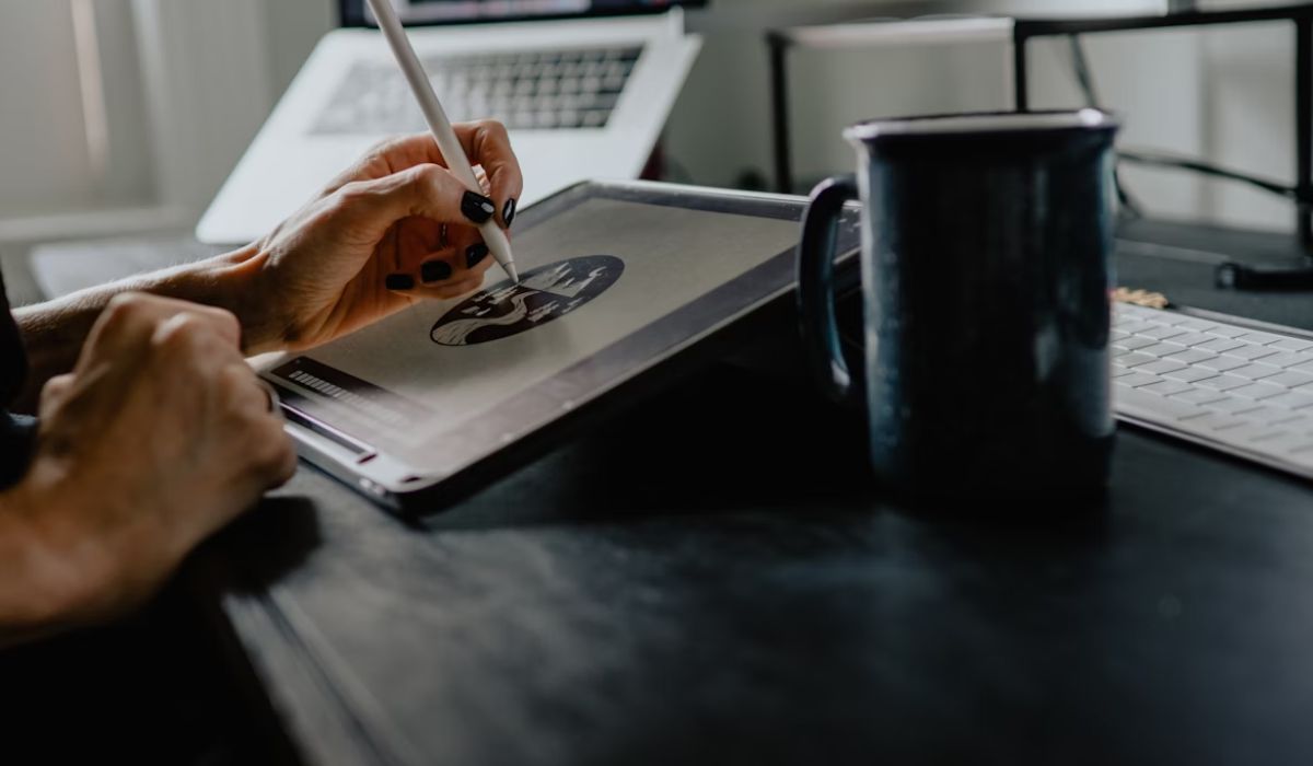 A graphic designer working on a tablet