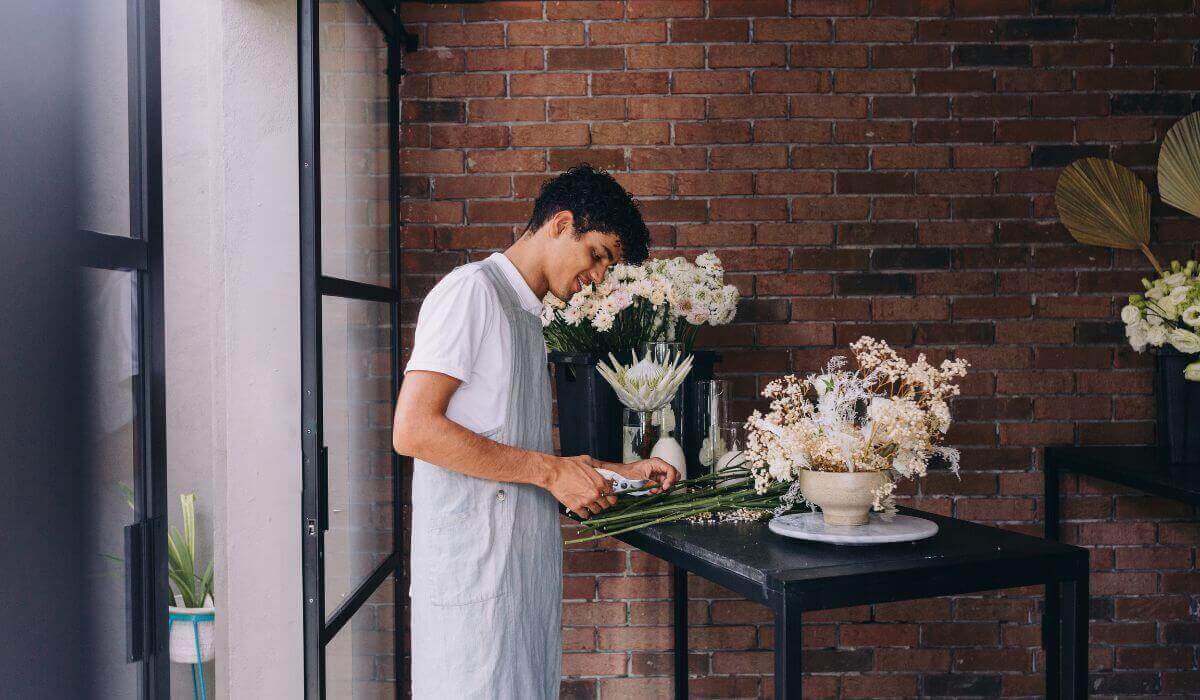 florist arranging flowers in a bouquet