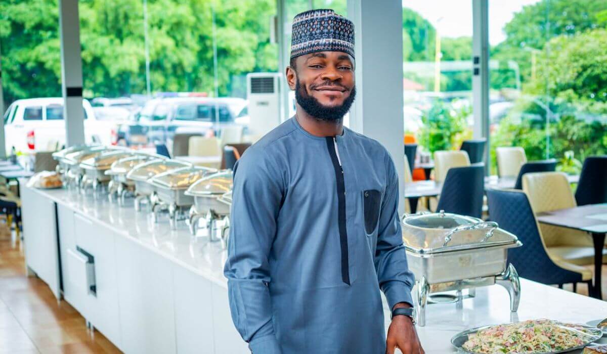 man owning a catering business standing nearby food containers