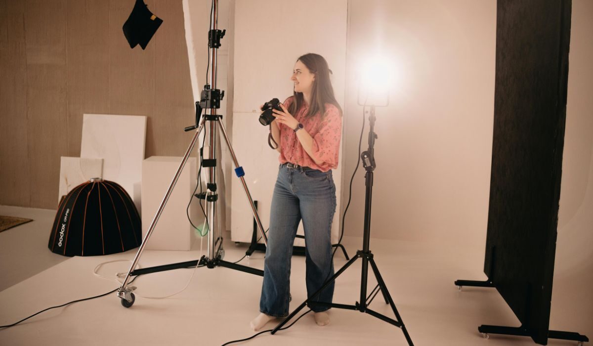 Freelance photographer standing in a photo studio