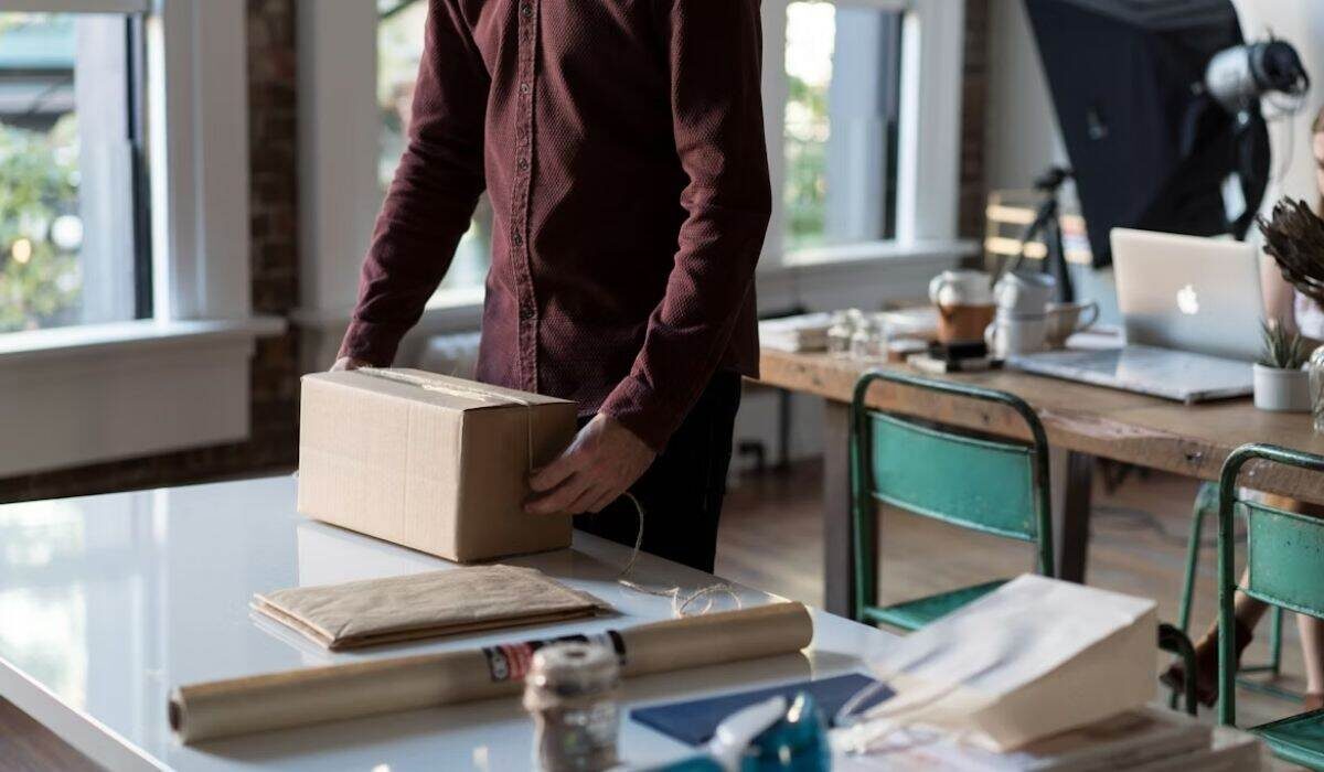 Small business owner packing a order for exporting it