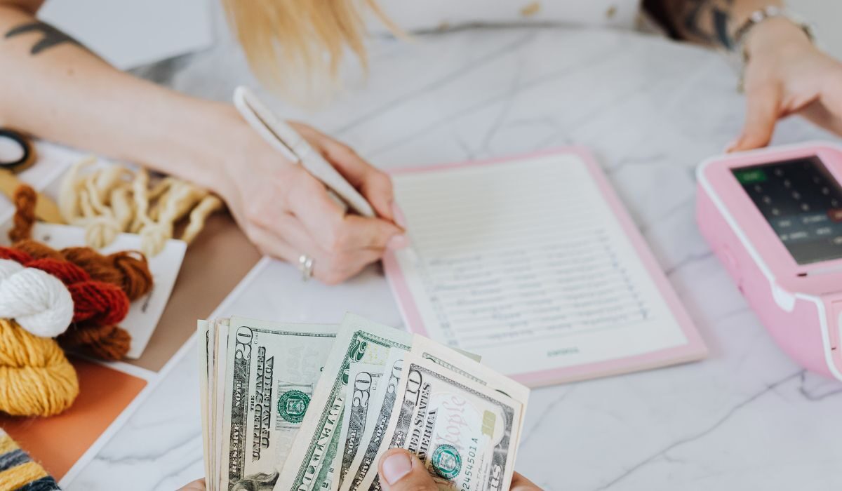 Woman estimating with a pen, book, calculator