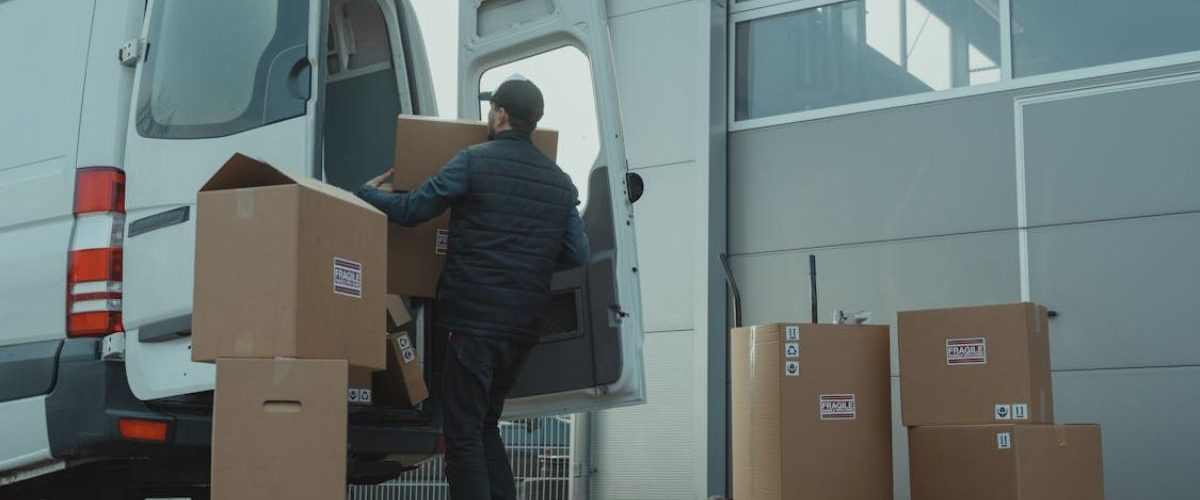 A man loading goods for delivery in a truck