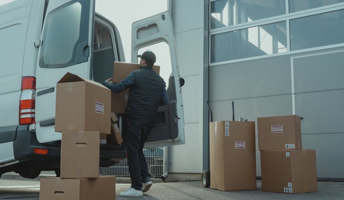 A man loading goods for delivery in a truck